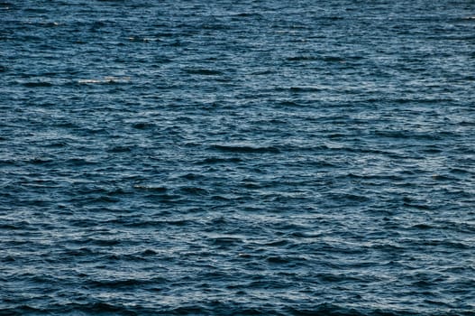 Blue Still Sea Water With Ripple. Natural Background Photo Texture