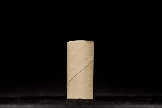 Empty Toilet Rolls Stack Up On a Black Background