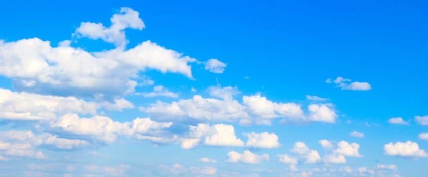 Blue sky background with tiny clouds