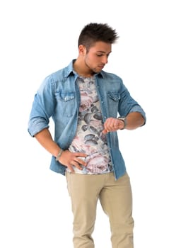 Handsome young man checking watch on his wrist, isolated on white