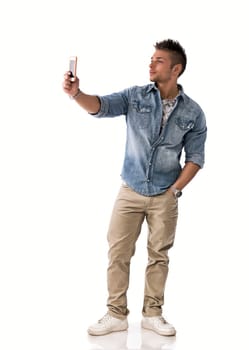 Full body shot of young man taking photo with cellphone, isolated on white