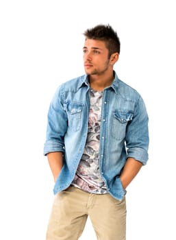 Handsome young man standing with open denim shirt, looking at camera, isolated
