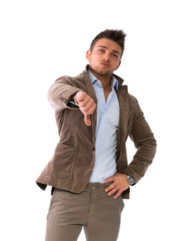 Handsome young man doing thumb down sign with hand, isolated on white
