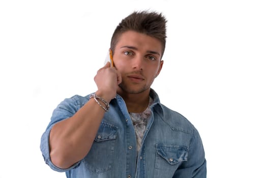 Handsome young man talking on cell phone (mobile), isolated on white. Looking at camera