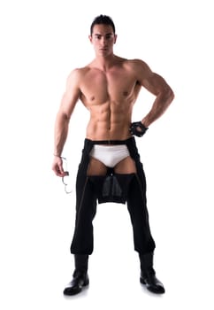 Muscular shirtless young man with handcuffs and studded glove. Full body length shot