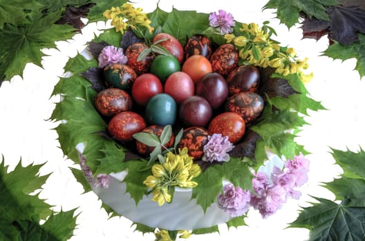 Very beautiful and colorful eggs inside a plate with mirror floor.
