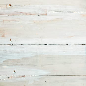 Background texture of painted or whitewashed white wooden boards with a mottled brushstroke pattern in square format with copyspace for your text