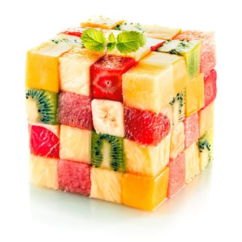 Fruit cube formed from small squares of assorted tropical fruit in a colorful arrangement including kiwifruit, strawberry, orange, banana and pineapple on a white background