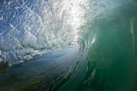 Ocean wave crashing water power energy on shallow reefs nearby beach coastline