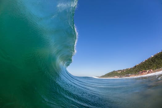 Ocean wave crashing water power energy on shallow reefs nearby beach coastline
