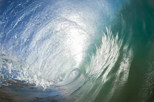 Ocean wave crashing water power energy on shallow reefs nearby beach coastline