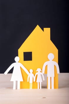 White Paper Chain Family with their House in front of a black Background