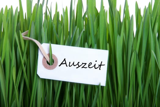 White Banner with the German Word Auszeit which means Downtime, in the Gras