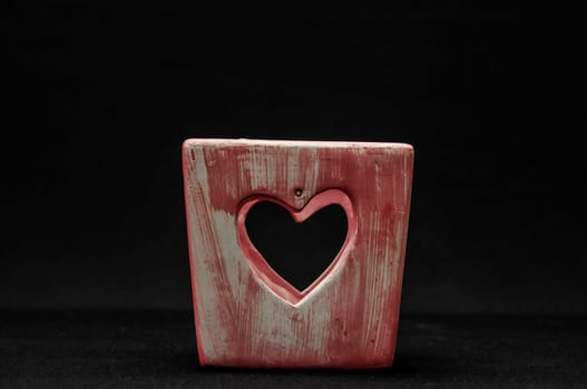 Colorful designed clay vase over a Black background