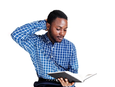 A protract picture of a black man in a blue shirt standing and holding a book .in his hands, isolated for white background..