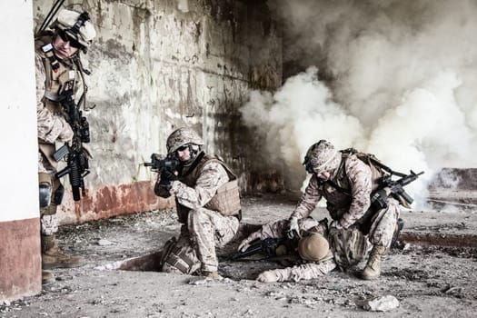 Squad of US marines in action in ruined building
