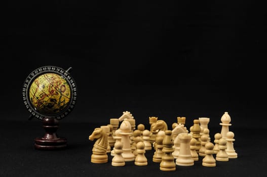 Globe And White Chess on a Black Background