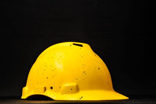 Yellow Safety Helmet on a Black Background