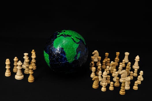 Globe And White Chess on a Black Background