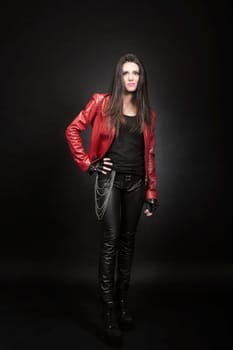 Young brunette woman against black background, Fashion portrait