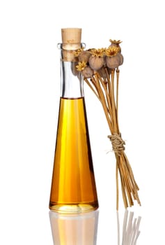 Bottle of poppy seed oil and poppy pods mirrored