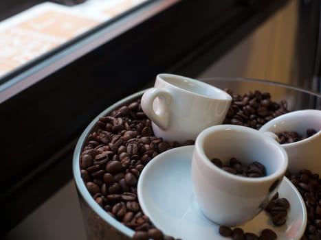 View of coffee cups and coffee beans