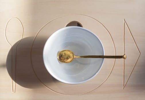 View of cup and spoon on wooden background