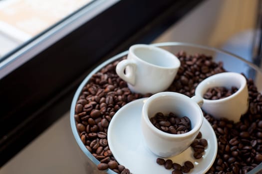 View of coffee cups and coffee beans