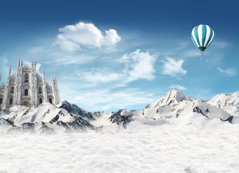 Milan Cathedral among the mountains with snow and hot air balloon flying in the sky