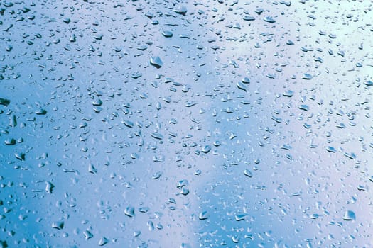 Water drops on window glass, blurred on the edges