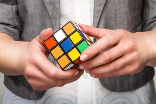 Hands holding or playing color cube game for concept solve solutionsolding color cube