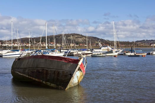 A wooden fishing boat stranded at low tide