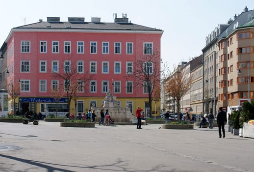 Vienna,Austria - March 30,2014: Passers-by,tourists and families on the Siebenbrunnenplatz in fine weather on March 30,2014 in Vienna.