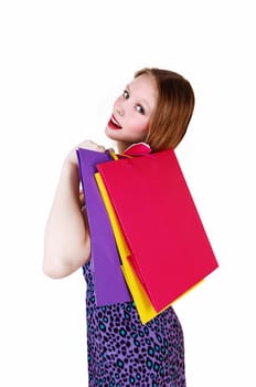 A nice teenage girl in a dress, holding shopping bag's over her shoulder.isolated for white background..