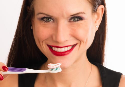 pretty woman holding toothbrushbefore brushing her teeth