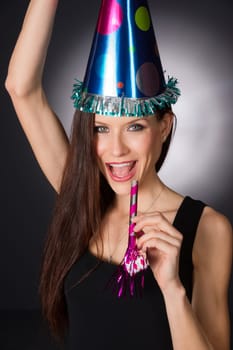 Beautiful woman at party waiting to make noise at midnight