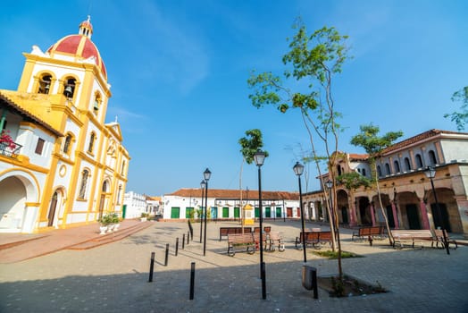Plaza in Mompox, Colombia with a cathedral and old abandoned market