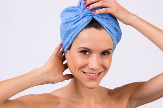 Beautiful woman just out of the shower wearing towel on her head