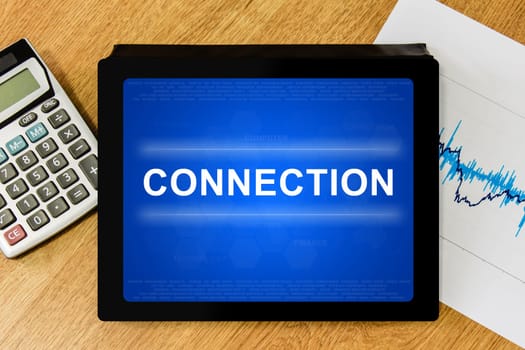 connection word on digital tablet with calculator and financial graph