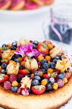 Closeup of delicious sponge cake topped with fresh berries