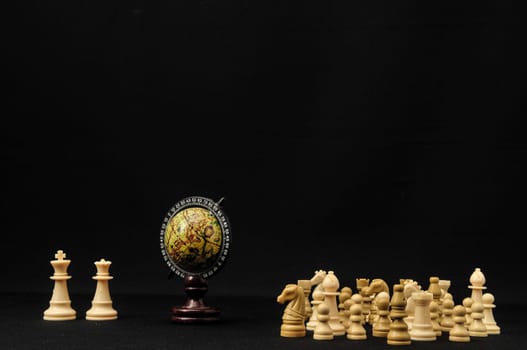 Globe And White Chess on a Black Background