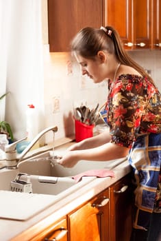 Portrait of housewife checking how clean is the glass bowl