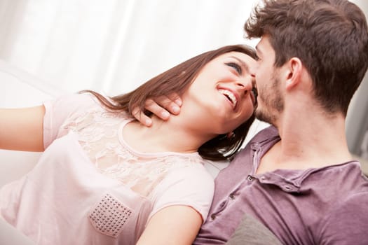 couple falling in love because she's looking at him with love while he holds her in his arms