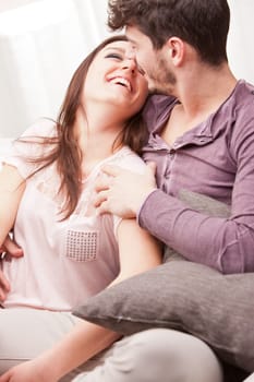 the girl smiles at him and he loves her while he holds her in his arms
