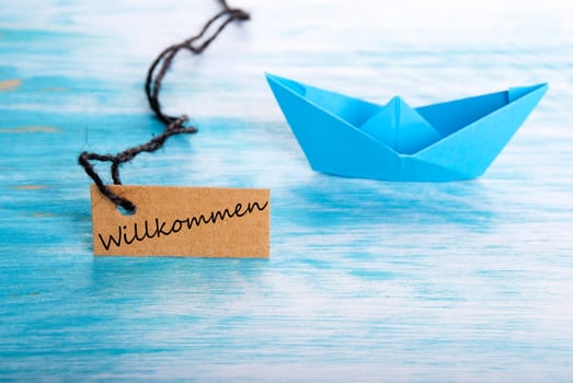 Natural Label with the German Word Willkommen which means Welcome and a Boat Background