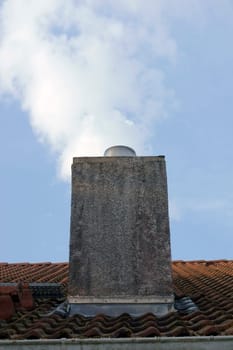 The photograph of a chimney behind which a cloud stands as if it were agony