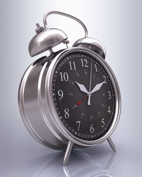 Old alarm clock on reflective background.