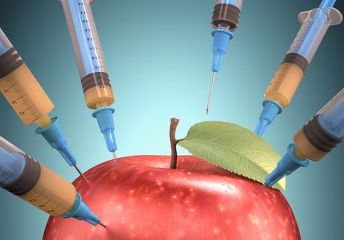 Several syringe taking the juice from apple. Clipping path included.