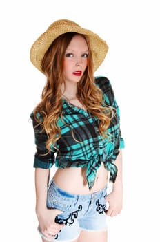 A lovely young teen girl in shorts and blouse with a straw hat standing.isolated for white background..