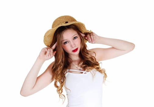 A lovely young woman with long curly blond hair wearing a beige straw.hat, isolated for white background..